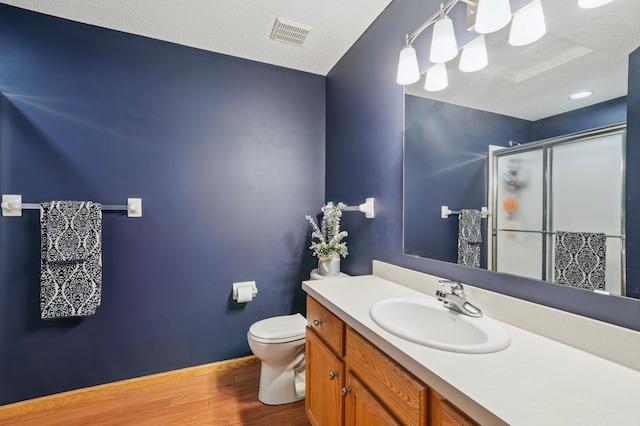 728 Elm St, Belle Plaine, MN 56011 - full bath featuring wood finished floors, a stall shower, and vanity