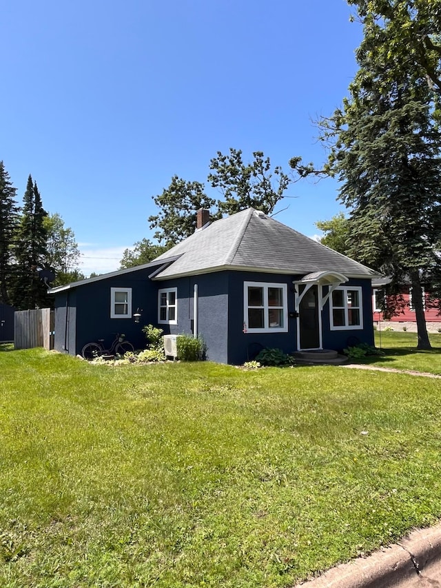 612 Poplar St, Crosby, MN 56441 - view of front facade with a front yard, a chimney, and stucco siding
