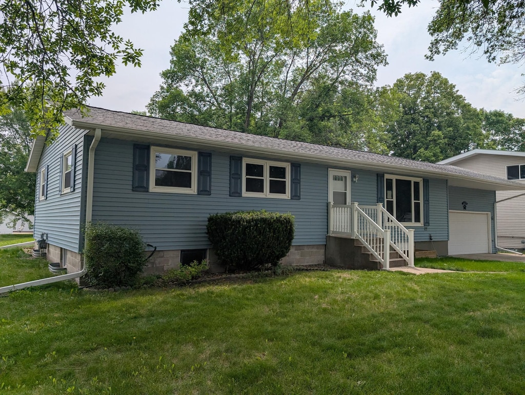 507 1st St, Marshall, MN 56258 - view of front of house featuring an attached garage and a front lawn