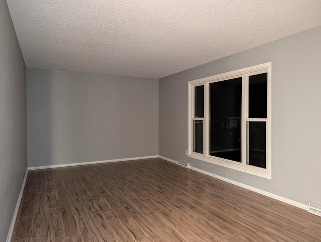 507 1st St, Marshall, MN 56258 - empty room with a textured ceiling and wood finished floors