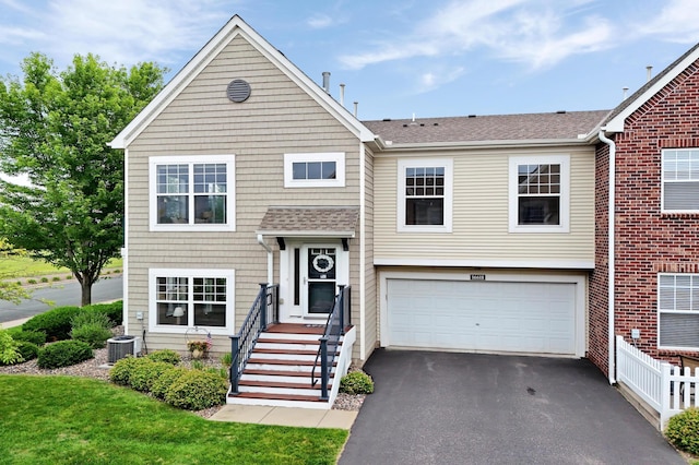 16618 72nd Ct NE, Otsego, MN 55330 - raised ranch with asphalt driveway, an attached garage, and roof with shingles