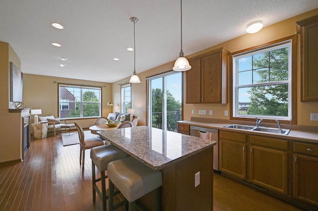 16618 72nd Ct NE, Otsego, MN 55330 - kitchen featuring stainless steel dishwasher, a kitchen breakfast bar, a center island, hanging light fixtures, and open floor plan