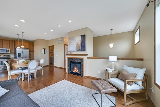 16618 72nd Ct NE, Otsego, MN 55330 - living area with wood finished floors, recessed lighting, and a glass covered fireplace