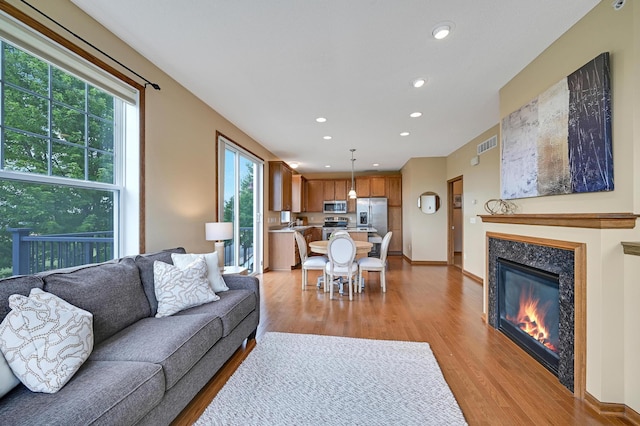 16618 72nd Ct NE, Otsego, MN 55330 - living room with light wood finished floors, recessed lighting, and a glass covered fireplace