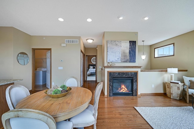 16618 72nd Ct NE, Otsego, MN 55330 - dining room with wood finished floors, a glass covered fireplace, and recessed lighting