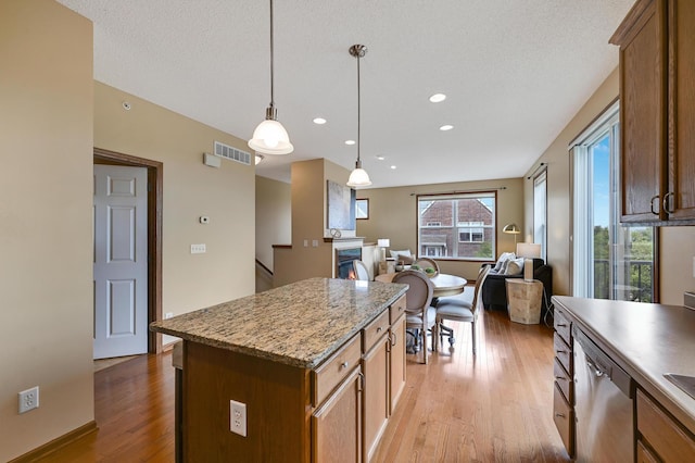 16618 72nd Ct NE, Otsego, MN 55330 - kitchen with stainless steel dishwasher, open floor plan, light wood-style flooring, a center island, and decorative light fixtures