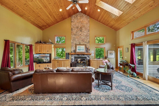 940 Brown Rd S, Wayzata, MN 55391 - living area featuring high vaulted ceiling, a stone fireplace, a ceiling fan, a skylight, and plenty of natural light