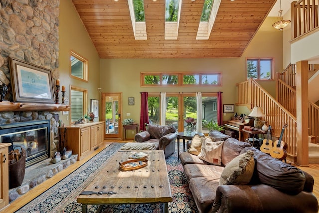 940 Brown Rd S, Wayzata, MN 55391 - living area with high vaulted ceiling, wood finished floors, stairway, a stone fireplace, and a skylight