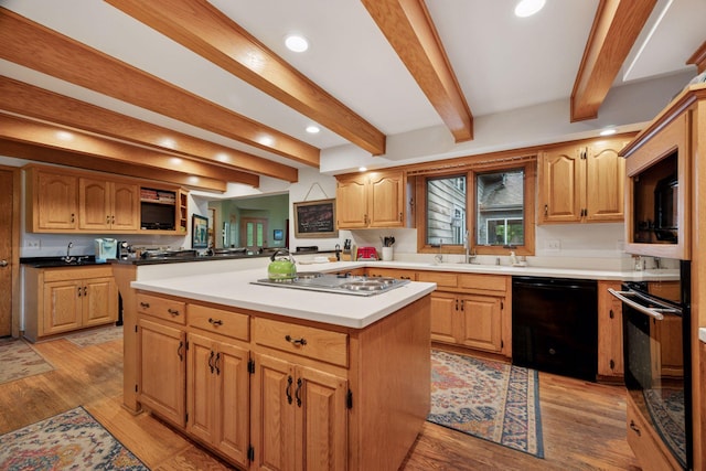 940 Brown Rd S, Wayzata, MN 55391 - kitchen featuring black appliances, beam ceiling, a kitchen island, recessed lighting, and light wood-style flooring