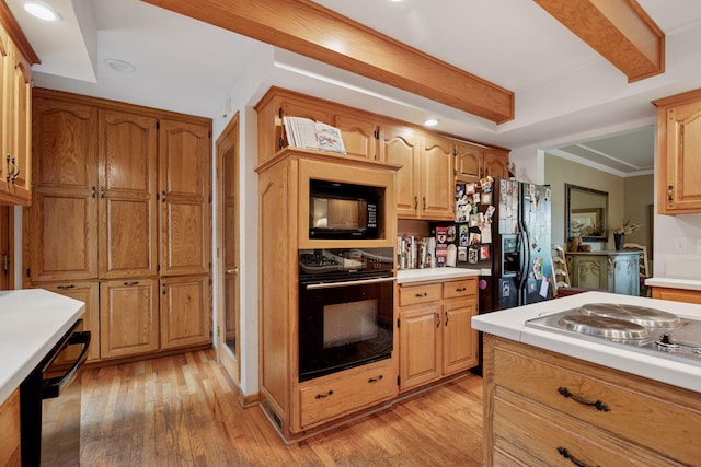 940 Brown Rd S, Wayzata, MN 55391 - kitchen with black appliances, light countertops, light wood-type flooring, recessed lighting, and ornamental molding