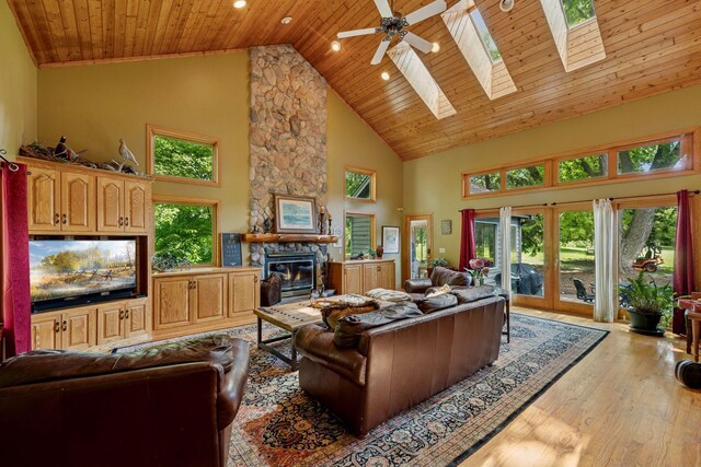 940 Brown Rd S, Wayzata, MN 55391 - living room with high vaulted ceiling, a fireplace, light wood-style floors, a skylight, and wood ceiling
