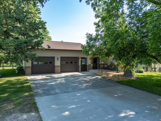 350 3rd St NE, Mcintosh, MN 56556 - view of front of house with concrete driveway, a garage, a front yard, and brick siding