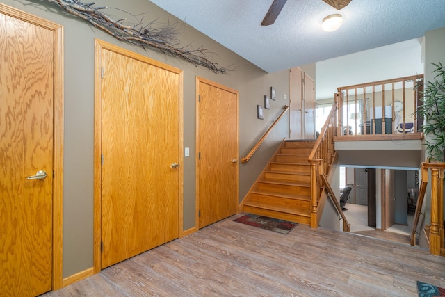 350 3rd St NE, Mcintosh, MN 56556 - staircase featuring wood finished floors, ceiling fan, and a textured ceiling