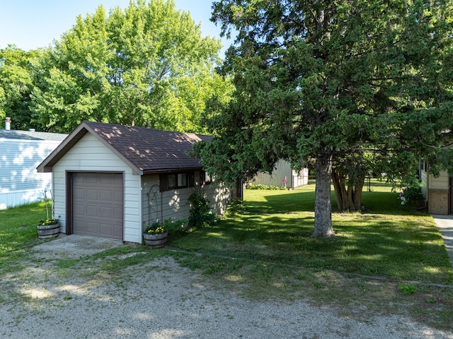 350 3rd St NE, Mcintosh, MN 56556 - view of green lawn with driveway, a garage, and an outdoor structure