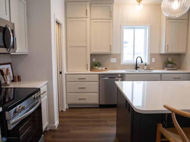 1449 66th Ave S, Fargo, ND 58104 - kitchen featuring stainless steel appliances, decorative backsplash, and light countertops