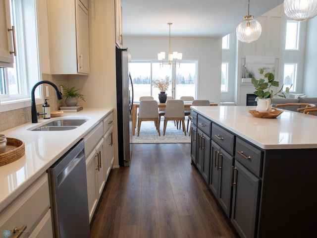 1449 66th Ave S, Fargo, ND 58104 - kitchen with stainless steel appliances, healthy amount of natural light, dark wood-style floors, and light countertops