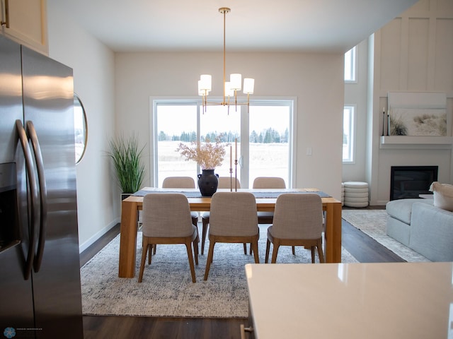 1449 66th Ave S, Fargo, ND 58104 - dining room featuring dark wood-type flooring, a chandelier, and a glass covered fireplace