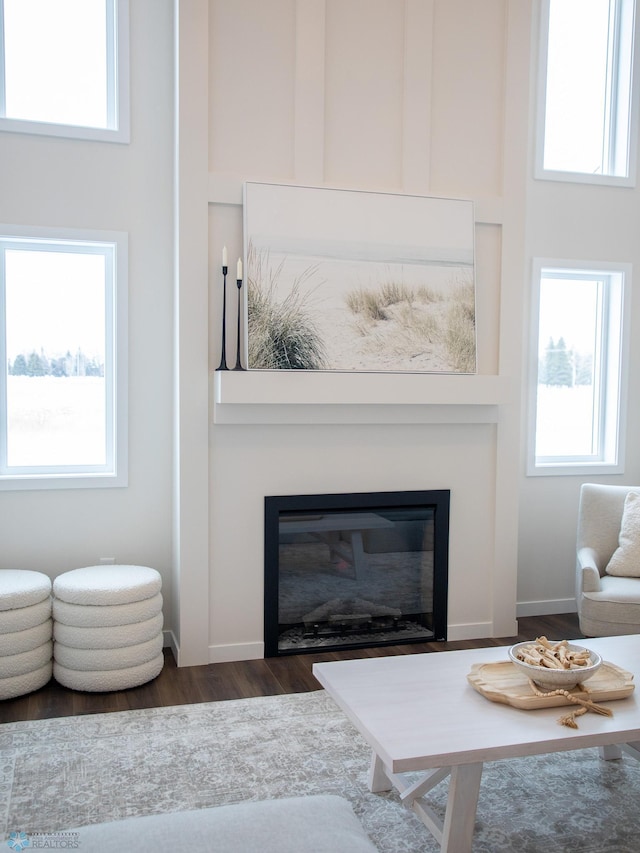 1449 66th Ave S, Fargo, ND 58104 - living area featuring a glass covered fireplace, dark wood-style flooring, and healthy amount of natural light