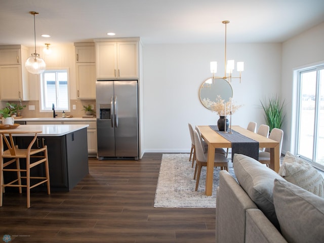 1449 66th Ave S, Fargo, ND 58104 - kitchen with stainless steel fridge, a chandelier, recessed lighting, light countertops, and dark wood-style flooring