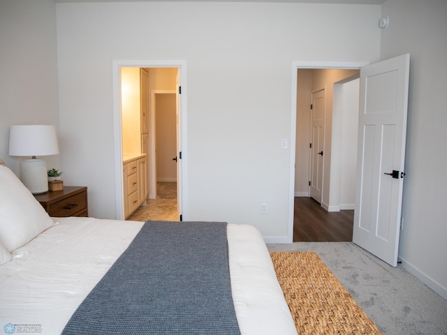 1449 66th Ave S, Fargo, ND 58104 - bedroom featuring light carpet and ensuite bath