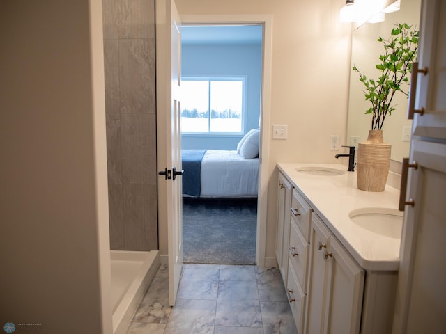 1449 66th Ave S, Fargo, ND 58104 - full bathroom featuring double vanity, marble finish flooring, connected bathroom, and a shower