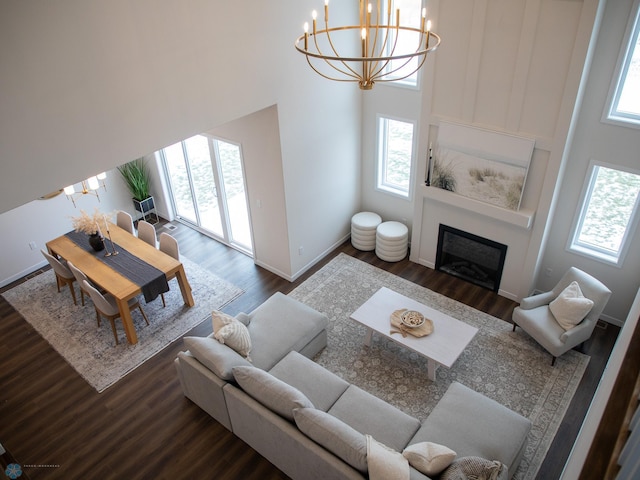 1449 66th Ave S, Fargo, ND 58104 - living area with a chandelier, dark wood finished floors, a glass covered fireplace, and a high ceiling