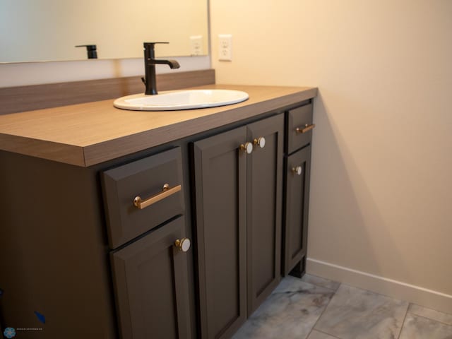 1449 66th Ave S, Fargo, ND 58104 - bathroom with vanity and baseboards