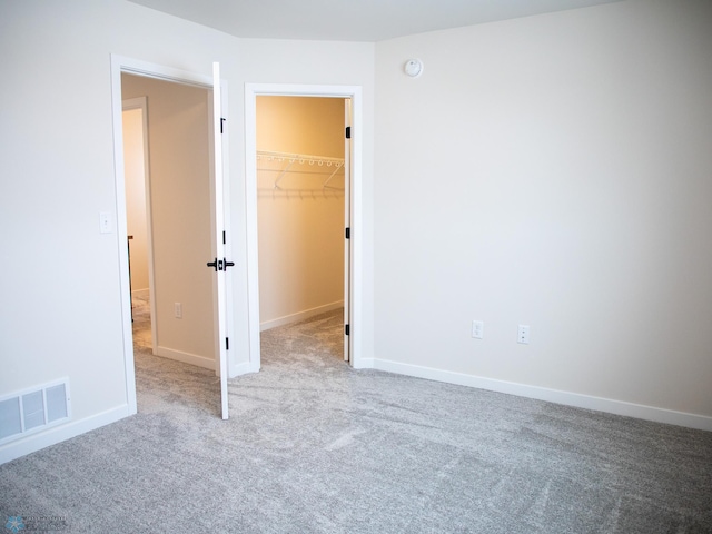1449 66th Ave S, Fargo, ND 58104 - unfurnished bedroom featuring carpet floors, a walk in closet, and a closet