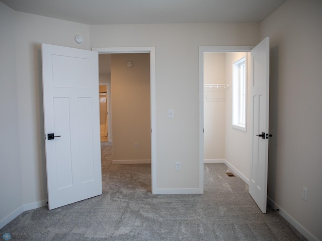 1449 66th Ave S, Fargo, ND 58104 - unfurnished bedroom with carpet floors, a spacious closet, and a closet