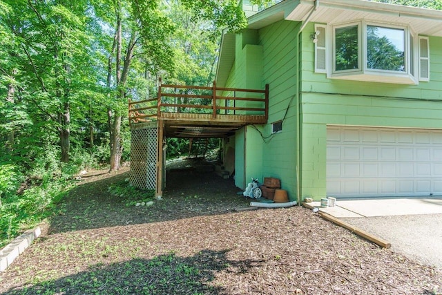 8335 Bush Lake Rd, Bloomington, MN 55438 - view of property exterior with a wooden deck, concrete driveway, and a garage