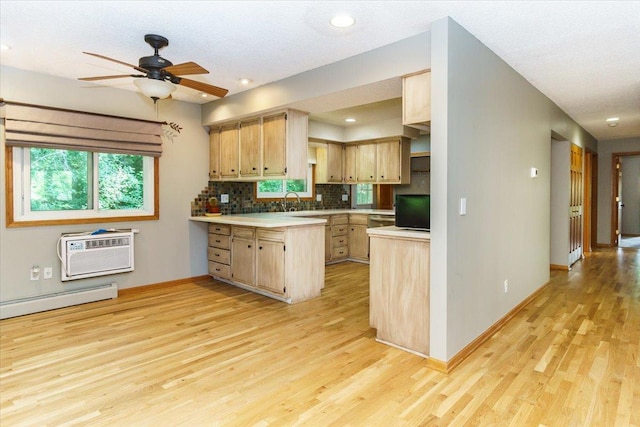 8335 Bush Lake Rd, Bloomington, MN 55438 - kitchen with light brown cabinetry, light wood finished floors, a baseboard radiator, light countertops, and a wall mounted air conditioner
