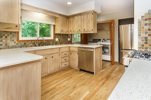 8335 Bush Lake Rd, Bloomington, MN 55438 - kitchen with appliances with stainless steel finishes, light countertops, light brown cabinetry, light wood-style flooring, and tasteful backsplash