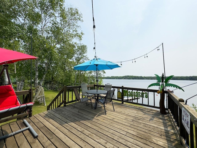 1198 Mink Rd, Ellsburg Twp, MN 55724 - wooden deck featuring a water view, outdoor dining area, and a yard