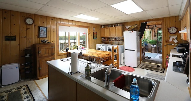 1198 Mink Rd, Ellsburg Twp, MN 55724 - kitchen with freestanding refrigerator, wooden walls, wall chimney exhaust hood, light countertops, and a drop ceiling