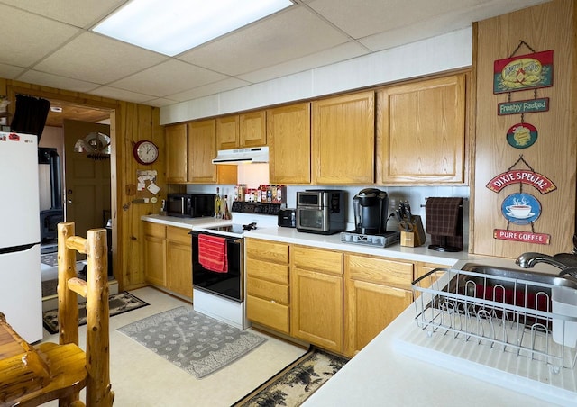 1198 Mink Rd, Ellsburg Twp, MN 55724 - kitchen with white appliances, under cabinet range hood, light countertops, a paneled ceiling, and brown cabinets