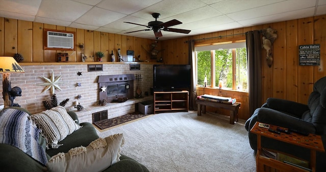 1198 Mink Rd, Ellsburg Twp, MN 55724 - carpeted living room with wood walls, a wall unit AC, ceiling fan, and a drop ceiling