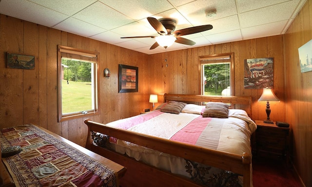 1198 Mink Rd, Ellsburg Twp, MN 55724 - bedroom featuring multiple windows, wood walls, and a ceiling fan