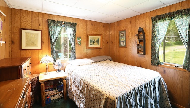 1198 Mink Rd, Ellsburg Twp, MN 55724 - bedroom featuring multiple windows, wood walls, and a drop ceiling