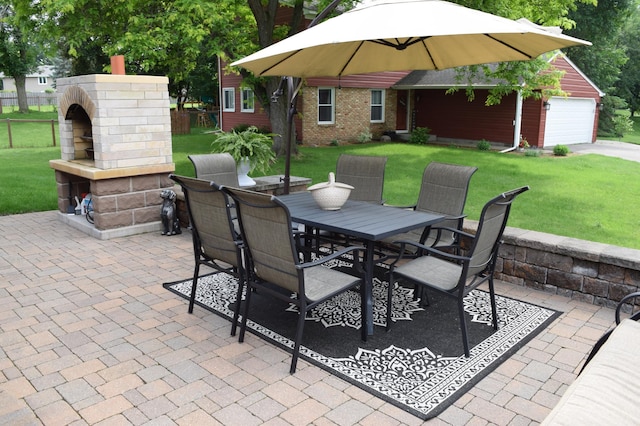 12115 50th Ave N, Plymouth, MN 55442 - view of patio featuring an outdoor brick fireplace, outdoor dining area, and a garage
