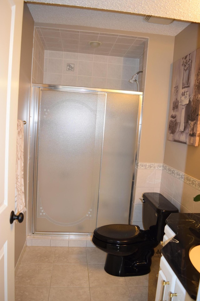 12115 50th Ave N, Plymouth, MN 55442 - bathroom with tile patterned flooring, vanity, a stall shower, tile walls, and wainscoting