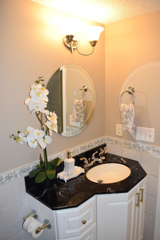 12115 50th Ave N, Plymouth, MN 55442 - bathroom with vanity, tile walls, tile patterned flooring, wainscoting, and a textured ceiling