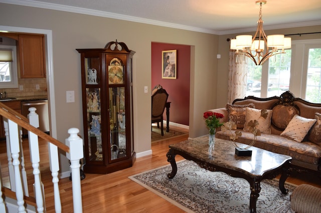 12115 50th Ave N, Plymouth, MN 55442 - living area with light wood-style floors, a chandelier, and ornamental molding