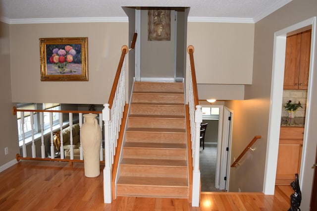 12115 50th Ave N, Plymouth, MN 55442 - staircase featuring wood finished floors, ornamental molding, plenty of natural light, and a textured ceiling
