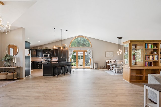 6257 185th Ave SE, Santiago Twp, MN 55308 - living area with a chandelier, light wood finished floors, and lofted ceiling