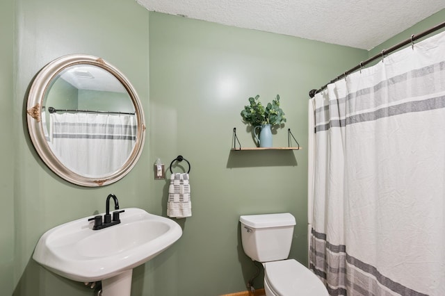 6257 185th Ave SE, Santiago Twp, MN 55308 - bathroom featuring toilet and a textured ceiling