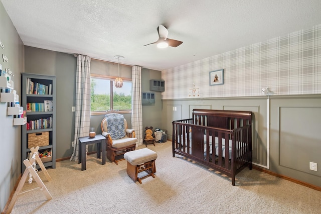 6257 185th Ave SE, Santiago Twp, MN 55308 - carpeted bedroom featuring a textured ceiling, a nursery area, ceiling fan, wallpapered walls, and a wall mounted AC