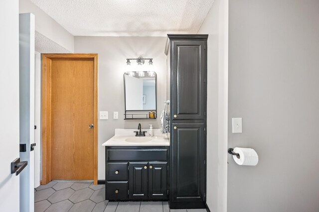 6257 185th Ave SE, Santiago Twp, MN 55308 - bathroom featuring vanity, a textured ceiling, and tile patterned flooring