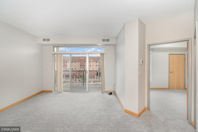 2600 University Ave SE Unit 318, Minneapolis, MN 55414 - carpeted spare room featuring baseboards and a textured ceiling