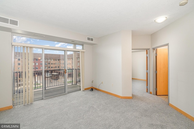 2600 University Ave SE Unit 318, Minneapolis, MN 55414 - unfurnished room with carpet flooring, a textured ceiling, and a smoke detector