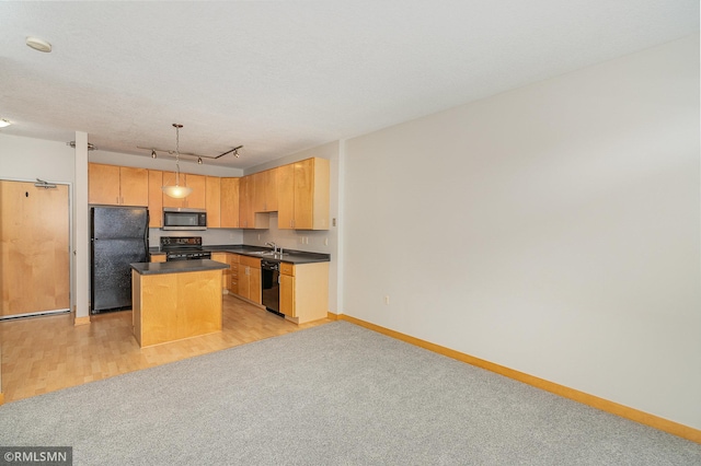 2600 University Ave SE Unit 318, Minneapolis, MN 55414 - kitchen featuring black appliances, dark countertops, a center island, light colored carpet, and hanging light fixtures
